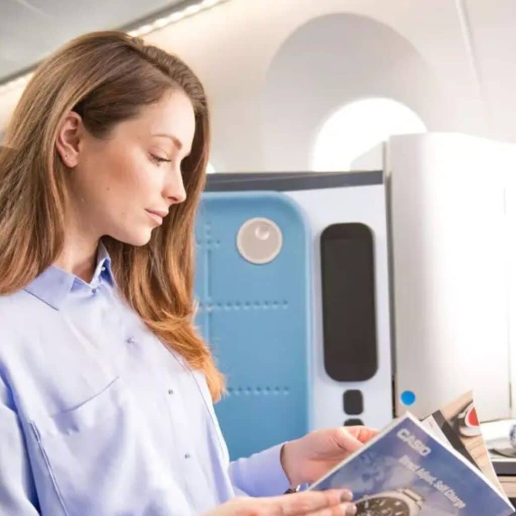 Woman reading a magazine aboard a KLM plane